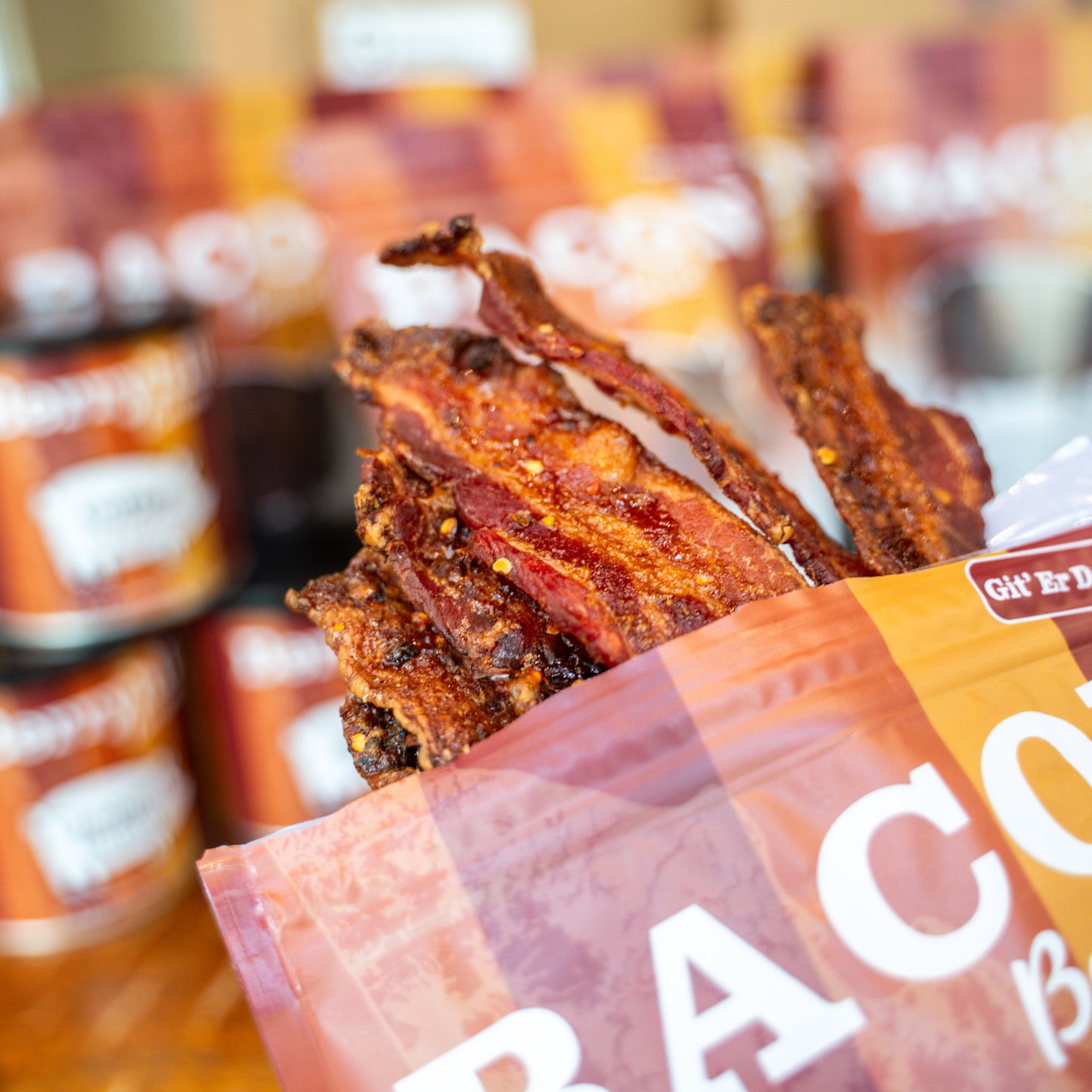 Picture of bacon coming out of a bag with other products in the background. 