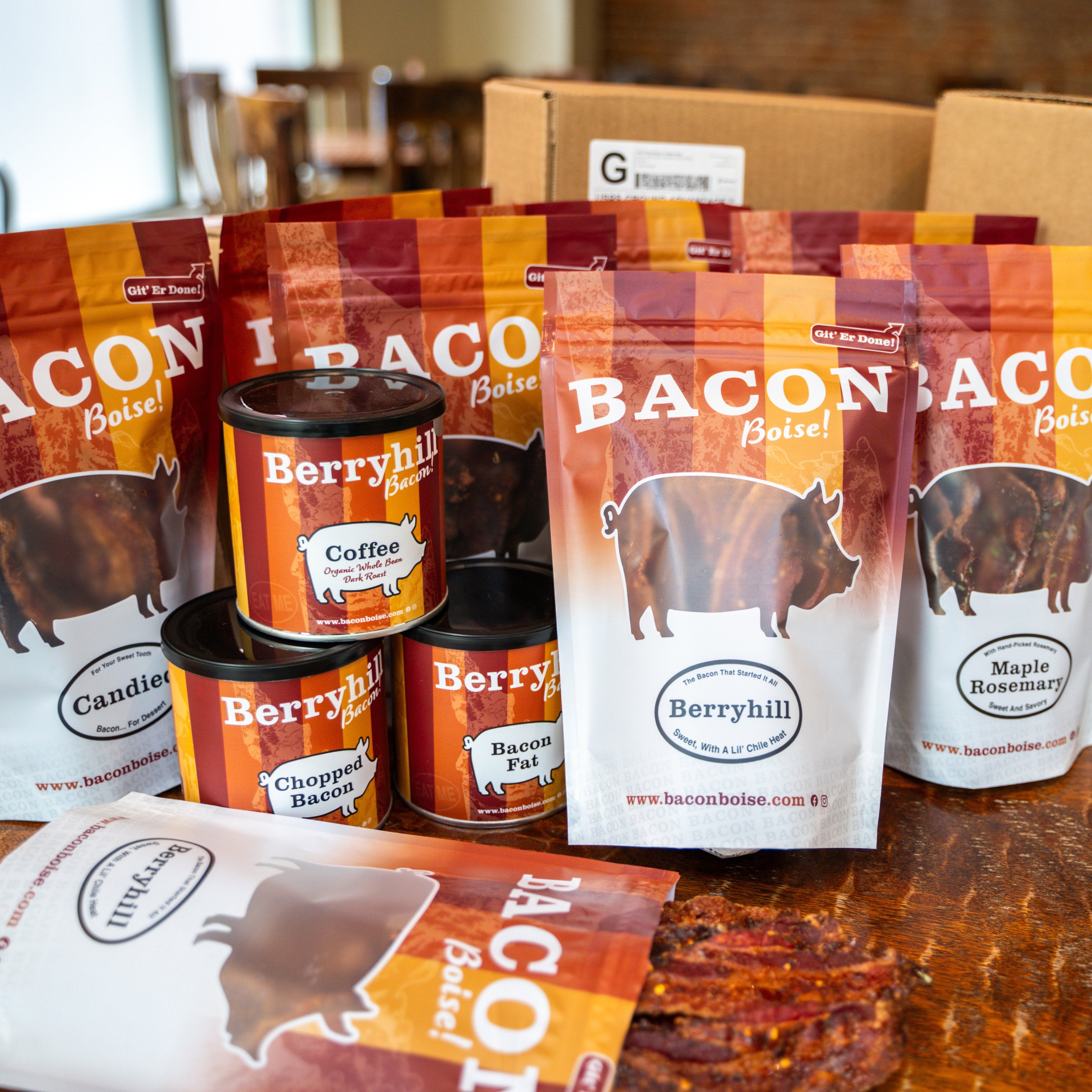 Bacon-based products including packages and cans on a wooden surface.