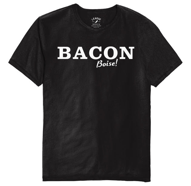 A black crew neck t-shirt with the word 'BACON' written in large white letters across the front, and the word 'BOISE!' written below in smaller white letters.